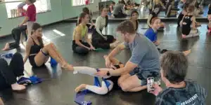 Dancers receiving injury-prevention exercises from a trainer – Dance Physical Therapy in Tampa Bay to improve strength, balance, and performance.